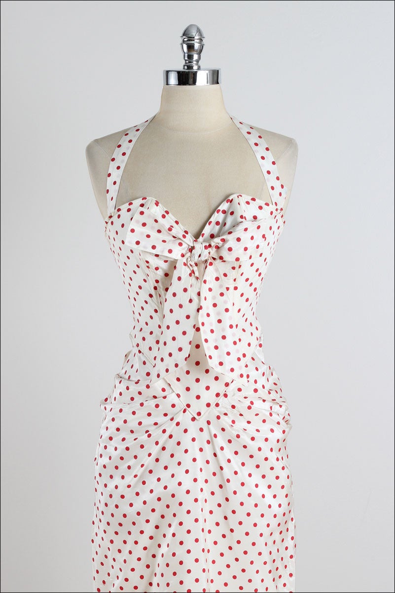 ➳ vintage 1950s dress

* white acetate with red polka dot print
* bow tie accent
* bodice stays
* halter straps
* fitted skirt
* metal back zipper

condition | excellent

fits like xs

length 39