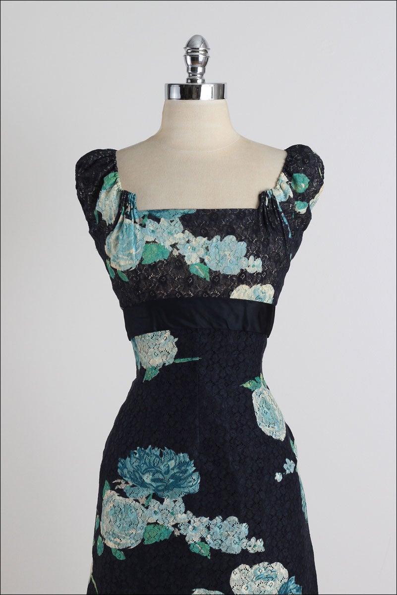 ➳ vintage 1950s dress

* deep blue painted lace
* acetate lining
* large floral print
* draped back accents
* elastic shoulder straps
* metal back zipper

condition | excellent

fits like medium

length 42