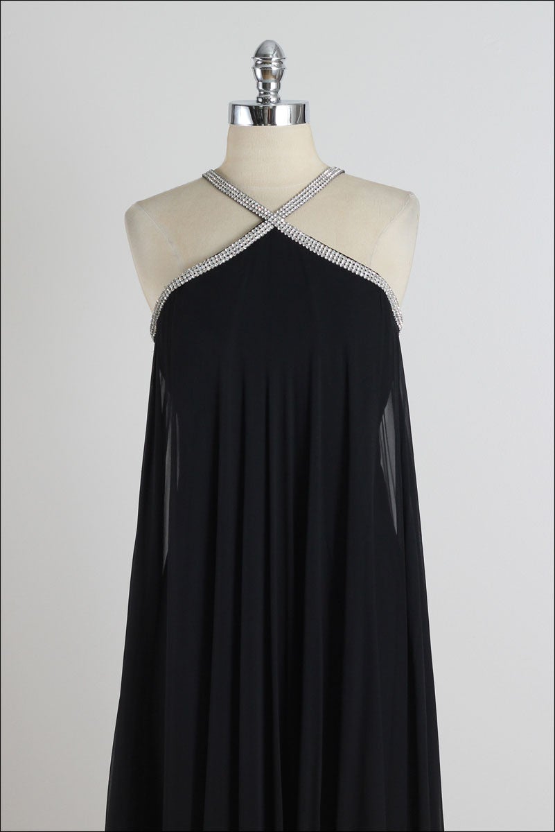 ➳ vintage 1960s dress

* gorgeous black silk crepe
* black silk lining
* beautiful rhinestone halter straps 
* bodice stays
* metal back zipper

condition | excellent 

fits like xs/s

dress length 49