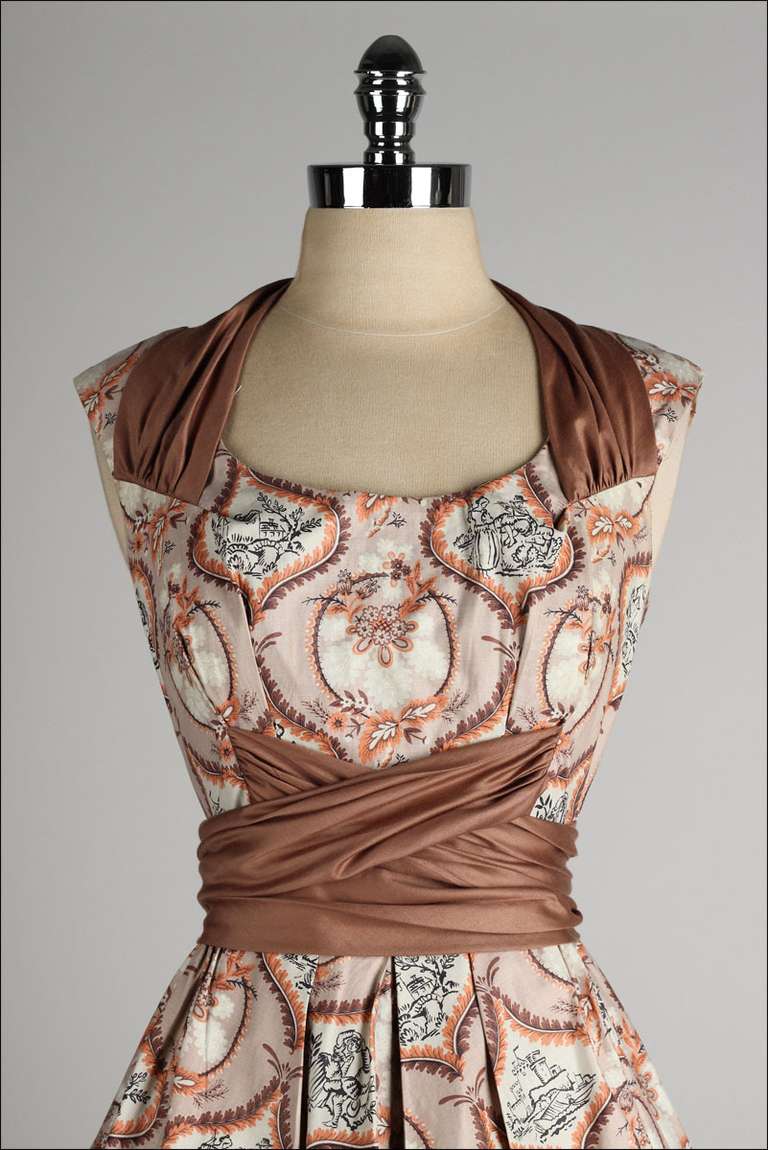 vintage 1950's dress

* brown/apricot polished cotton
* folk art Victorian era print
* criss/cross waist belt
* metal back zipper
* full skirt
* by Marjae of Miami

condition | excellent

fits like s/m

length 42