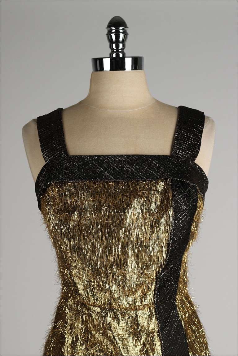vintage 1950's dress

* nylon blend
* acetate lining
* gold tinsel fringe
* brown metallic side stripe
* metal back zipper

condition | excellent

fits like large

length 40
