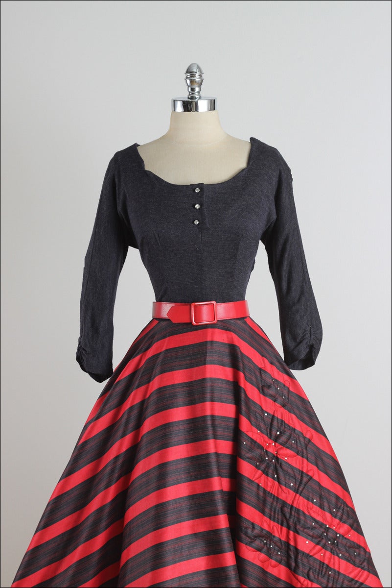 ➳ vintage 1950s dress

* red & navy striped wool blend
* tulle lining
* rhinestone accent front
* floral & rhinestone accents on skirt
* detachable belt
* metal side zipper

condition | excellent

fits like m/l

length 47