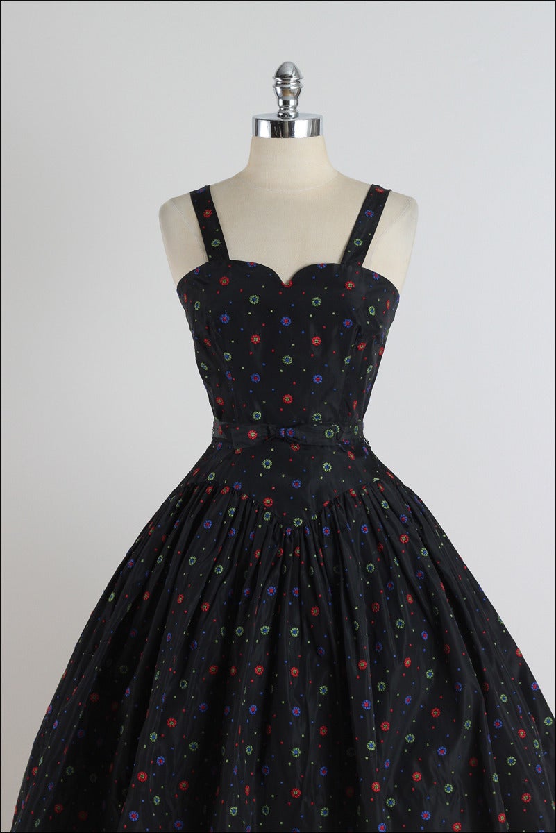 ➳ vintage 1950s dress

* black acetate with muslin lining
* colorful floral embroidery
* detachable belt with bow accent
* metal back zipper

condition | excellent

fits like xs

length 40