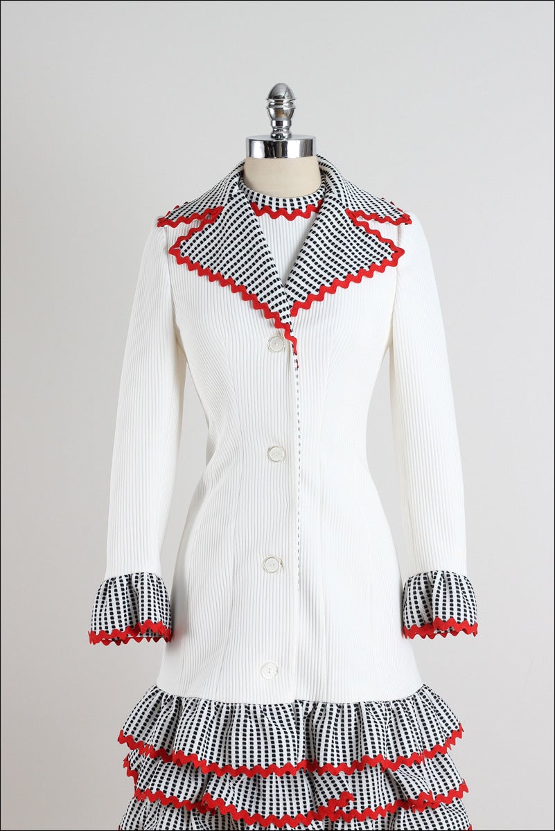 ➳ vintage 1960s dress and coat

* gorgeous white polyester knit
* black and white layering
* red ric rak trim
* ivory button front coat
* back zipper 
* by Lilli Ann

condition | perfect - appears to have never been worn

fits like