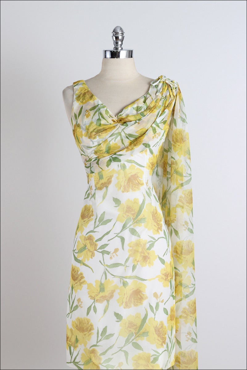 ➳ vintage 1950s dress

* yellow floral crepe chiffon
* acetate lining
* bodice lay over to shoulder sash
* bow tie accent
* metal back zipper

condition | excellent 

fits like medium

dress length 38