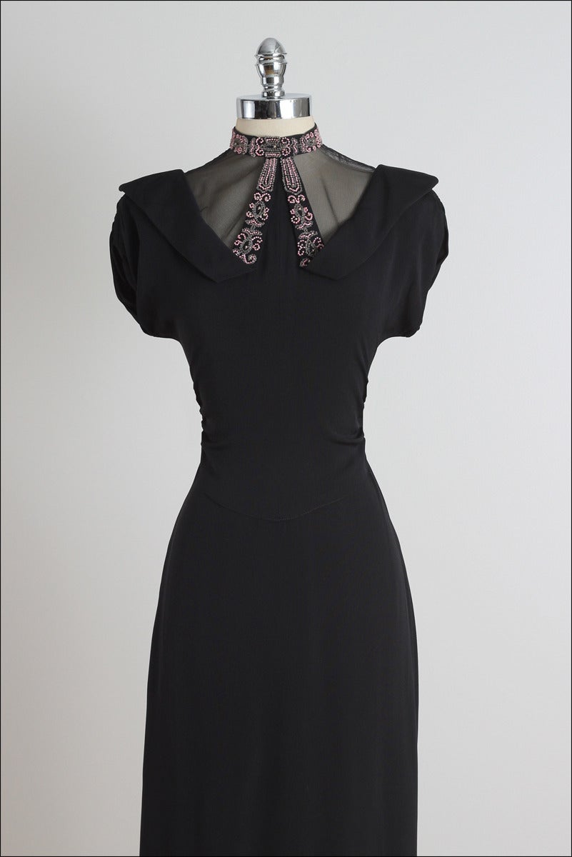 ➳ vintage 1940s dress

* black rayon crepe
* gorgeous beaded neck detail
* semi sheer neck line
* gathered sides & sleeves
* metal back zipper

condition | excellent 

fits like medium

dress length 44