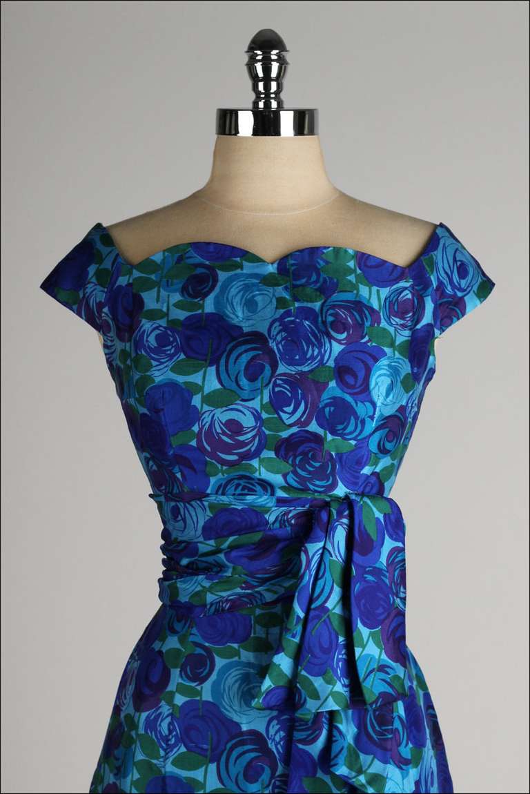 ➳ vintage 1950's dress

* blue/green/purple silk floral print
* shoulder sleeves
* shirred waist
* pleated sash accent
* wiggle fit
* metal back zipper
* by Gigi Young - New York

condition | excellent

fits like s/m

length