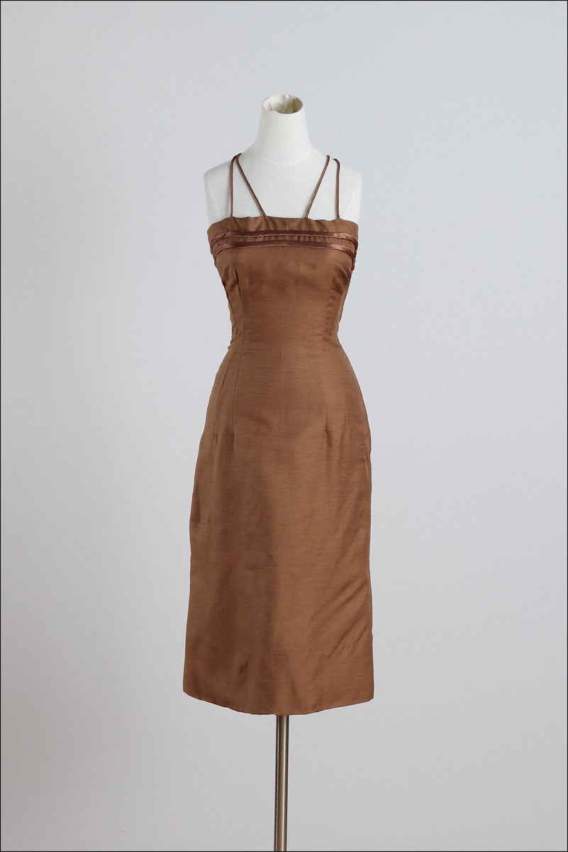 ➳ vintage 1950s dress and jacket

* bronze silk dupioni dress
* sheer bronze organza jacket
* bow accents
* silk straps & accents on dress
* metal side zipper

condition | excellent 

fits like small

dress length 35