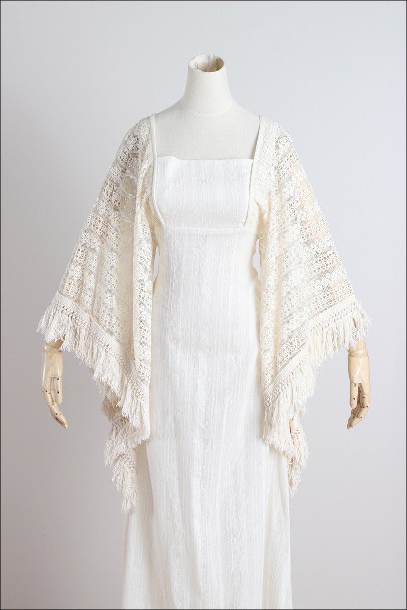 ➳ vintage 1970s dress

* semi sheer ivory cotton gauze
* floral lace sleeves & skirt
* dramatic angel sleeves
* thread fringe ends
* back zipper
* by Miss K for Alfred Shaheen

condition | excellent

fits like s/m

length 53