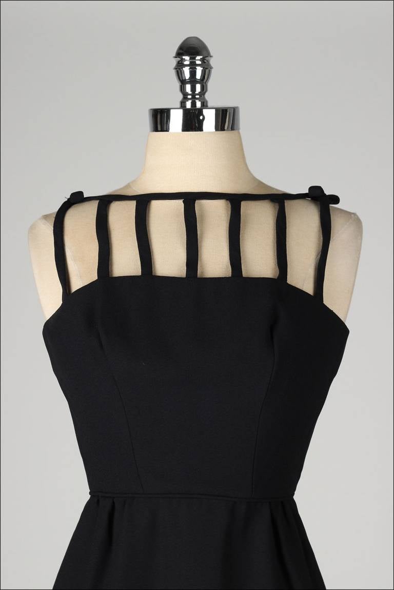 ➳ vintage 1950's wiggle dress

* black nylon blend
* acetate lined skirt
* caged top
* bows at shoulders
* metal back zipper
* by Candlelight by Savarese

condition | excellent

fits like xs

length 37