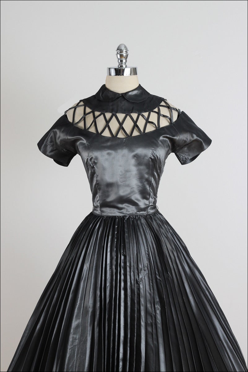 ➳ vintage 1950s dress

* gunmetal gray shark skin taffeta
* lattice bodice
* pleated skirt
* button back collar
* metal side zipper
* full skirt 

condition | excellent

fits like xs/s

length 45.5