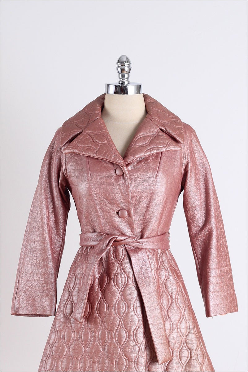 vintage 1960's coat

* pink metallic quilted vinyl
* acetate lining
* detachable belt
* pockets
* by Lilli Ann

fits like xs/s

condition | excellent

length 30