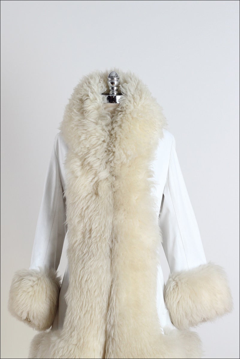 ➳ vintage 1960s coat

* white leather
* shearling trim
* acetate lining
* front pockets
* 2 front hooks
* attached back belt
* by Lilli Ann

condition | excellent 

fits like m/l

length 37