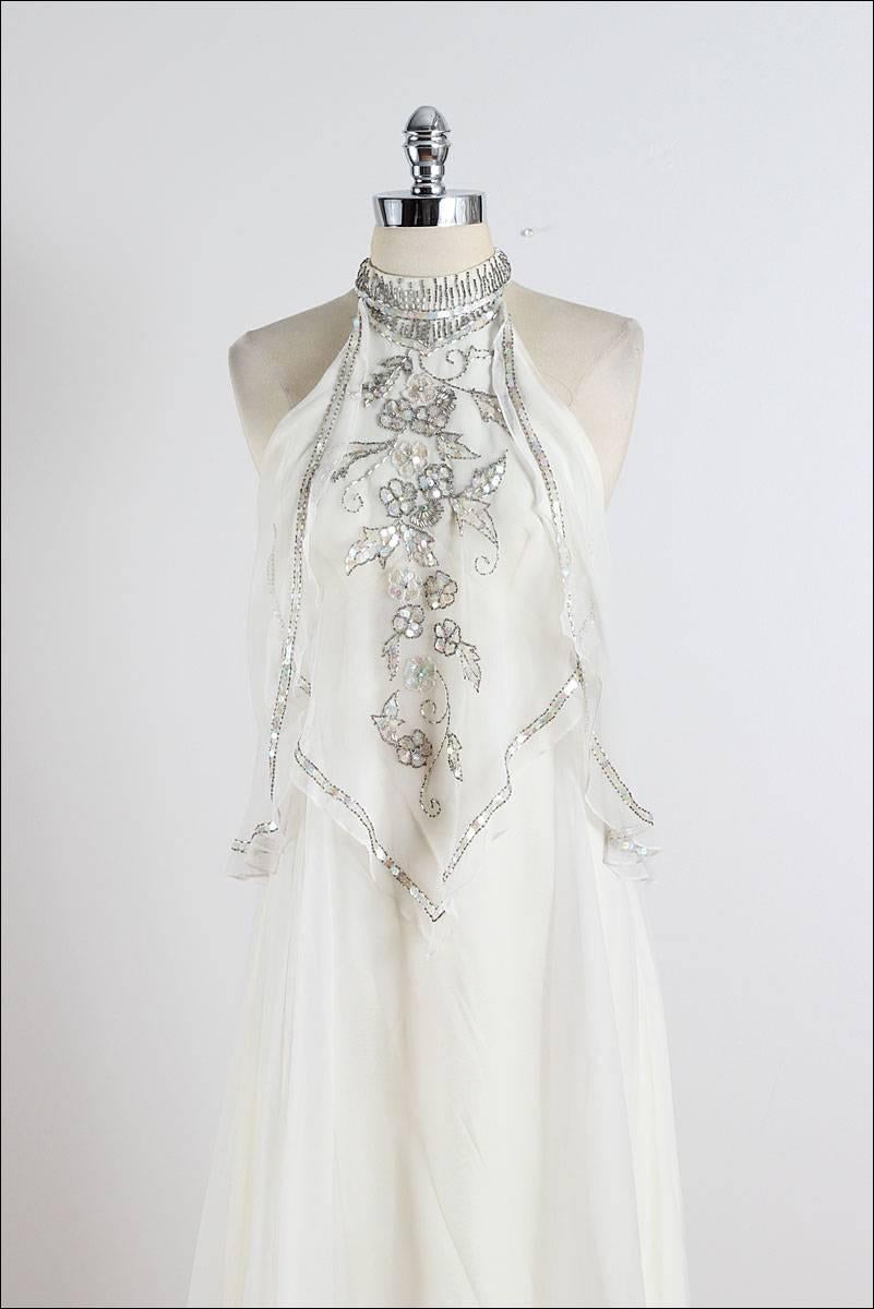 ➳ vintage 1970s dress

* ivory chiffon
* acetate lining
* beaded, rhinestone, sequin floral accents
* flowing layered bodice
* halter strap with hook back
* back zipper
* by Jack Bryan

condition | excellent 

fits like xs/s

length