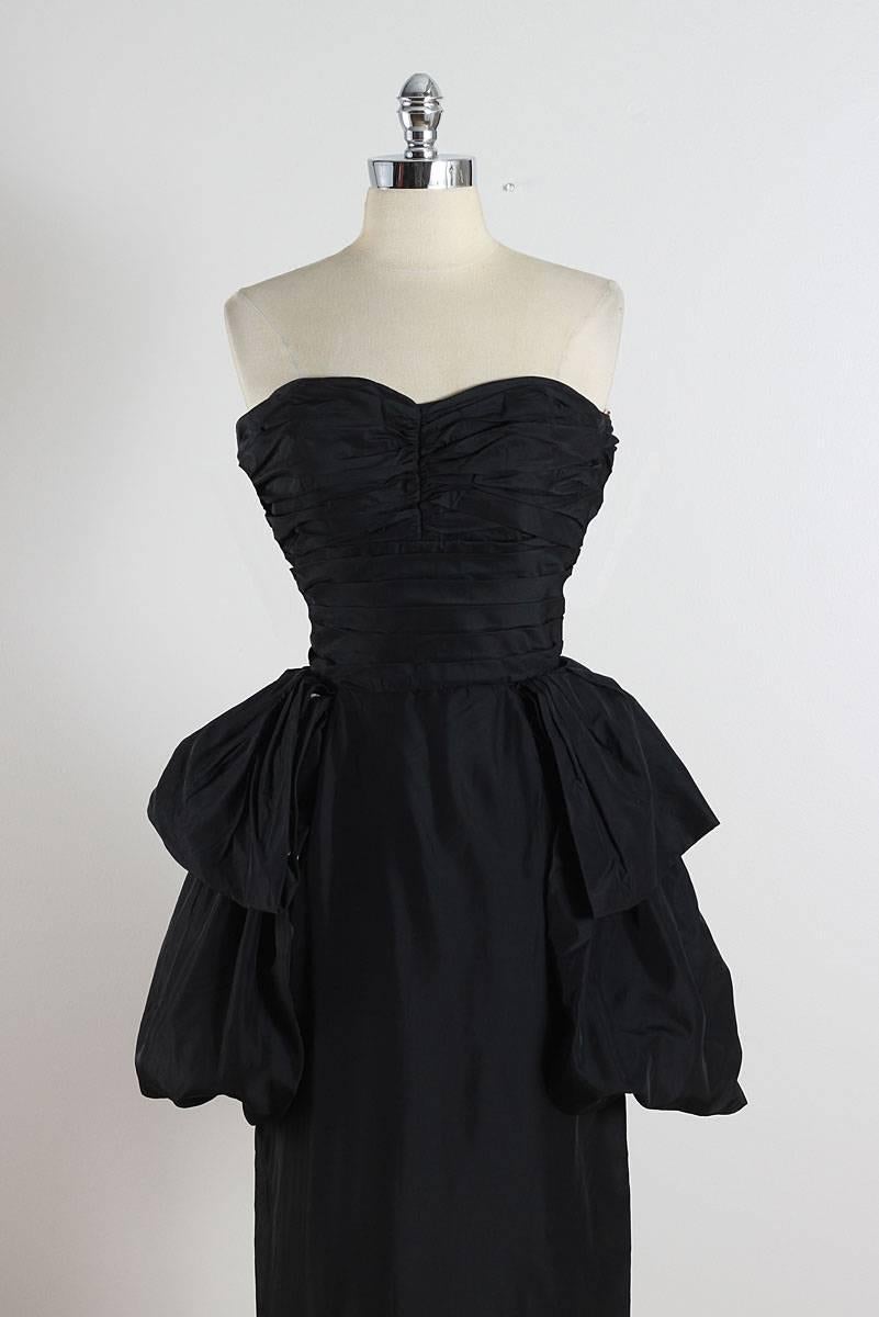 ➳ vintage 1950s dress

* black silk taffeta
* dramatic side peplums
* bodice stays
* gathered bodice
* metal back zipper
* by Clifton Wilhite

condition | excellent

fits like s/m

length 46