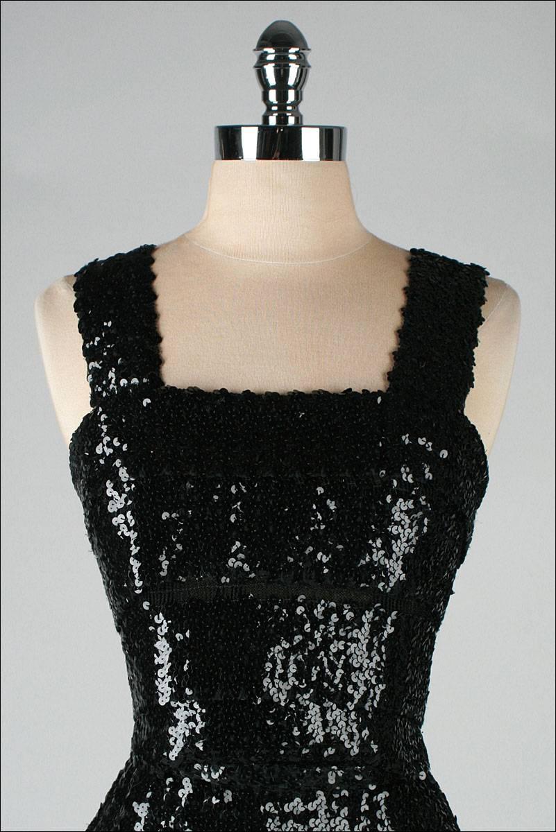 vintage 1950's dress

* black mesh covered in shiny black sequins
* tiered layers
* metal back zipper
* original snap closure belt
* by Rembrandt

condition | excellent

fits like xs/s

length 43