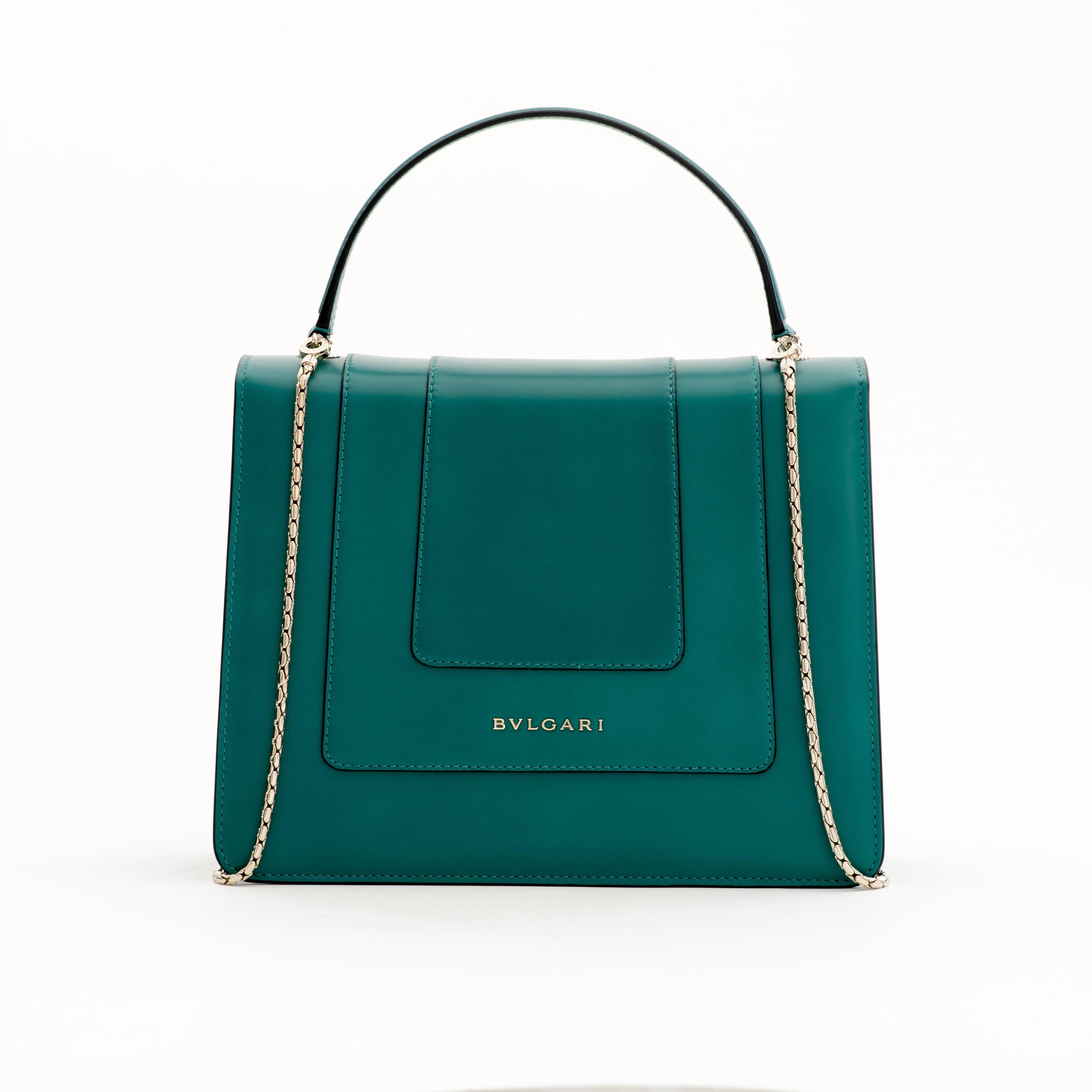 The Serpenti Bag first came out in 2012 and was inspired by the Bulgari wraparound watch. 

It features a light gold plate Snake head (Serpenti) closure. The Serpenti's eyes are made of malachite. The bag features a detachable chain strap in a