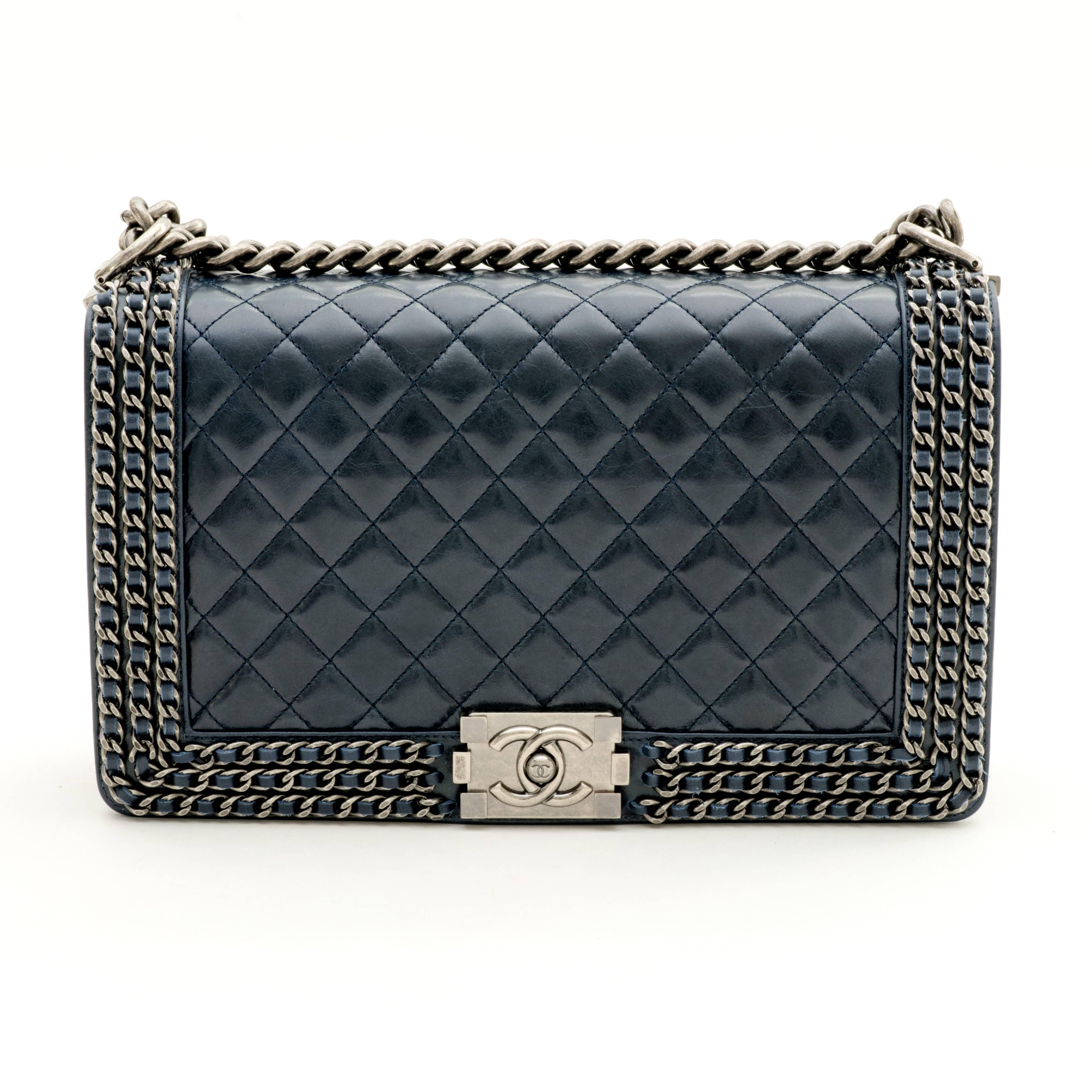 Chanel New Medium Chained Boy bag made of blue quilted leather with antique silver tone hardware.
 
This bag features a full front flap with the signature Le Boy CC push lock closure and a chain link, and leather shoulder/crossbody strap. 
 
The