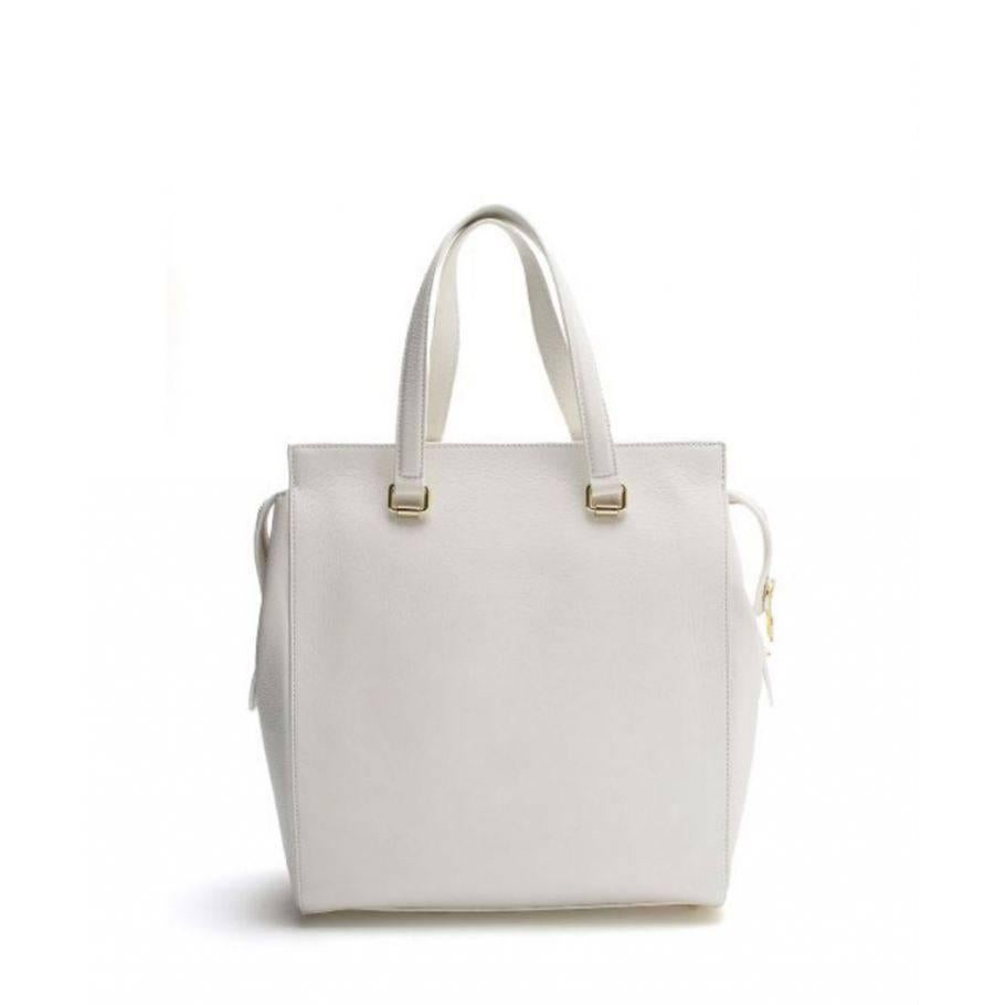 Sleek, stylish Versace bag for any formal and casual occasion.
Color: White
Leather with goldtone hardware
Cotton lined interior features zip pocket and 2 open pockets
Measures 12 x 12.8 x 4 in
Italy

Indicative dimensions
Width 12.8 in,