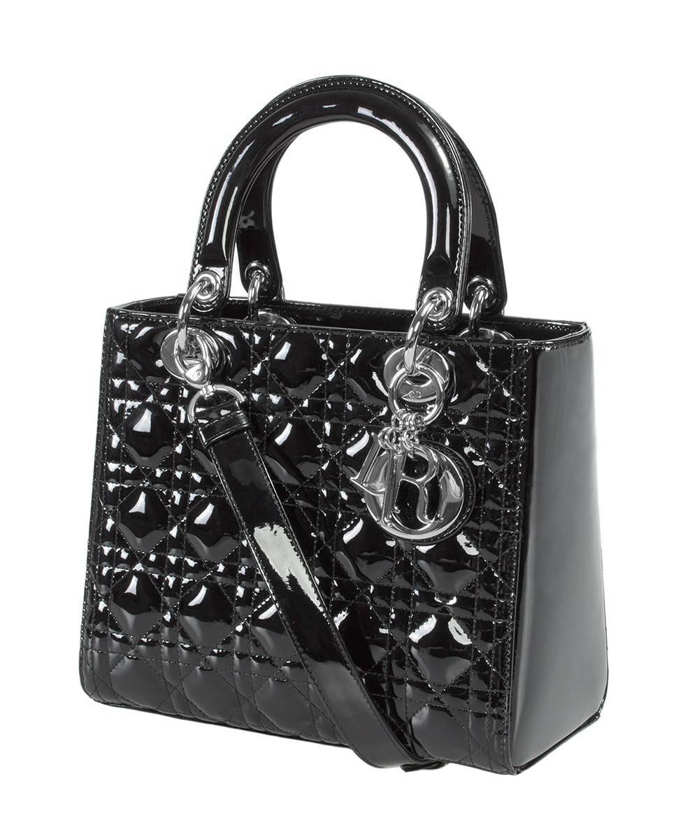 An unparalleled work of art, this black Lady Dior Patent Leather Bag is meticulously handcrafted utilizing high quality shiny and smooth patent leather from the legendary design house Christian Dior. The bag's timeless look consists of Dior's