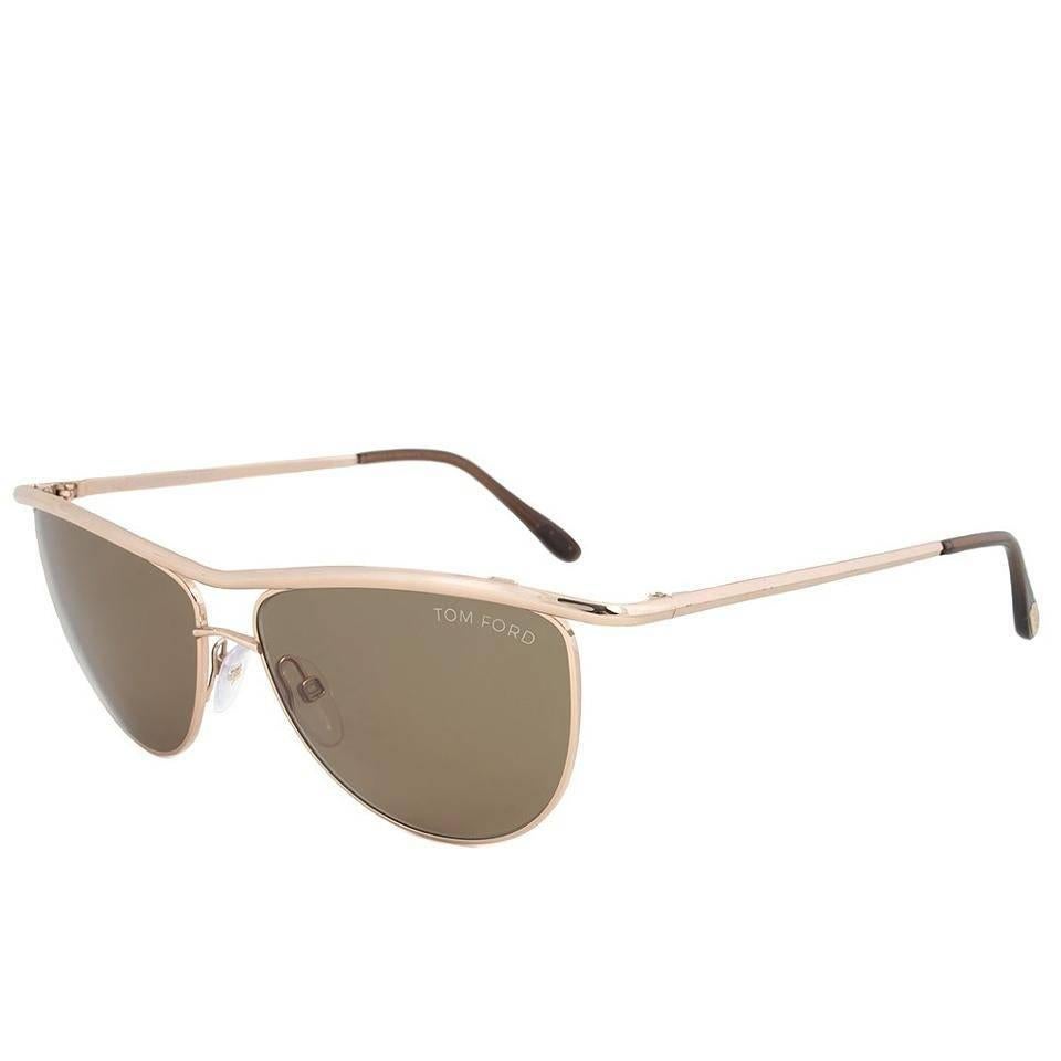 Tom Ford Helene Aviator Sunglasses, Gold and Brown (TF182)

These Tom Ford TF182 28J sunglasses showcase a stunning gold and brown two-tone full rim double bridge frame. The amber lenses, along with the brown ear socks with gold branding, provide