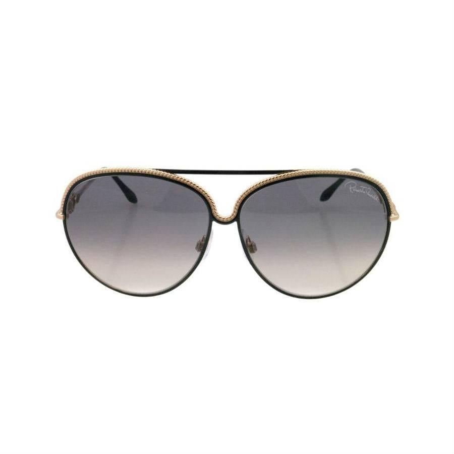 Roberto Cavalli Sunglasses, Gold and Black

These Roberto Cavalli sunglasses are made from high-quality, lightweight metal with 62mm grey lenses and rose-gold frame. These sunglasses absorb 100% of harmful UV spectrums to provide premium eye