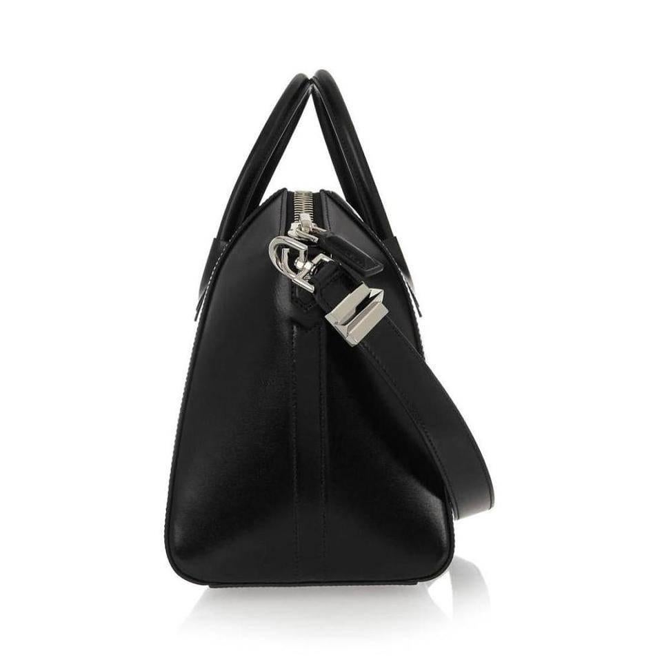 Givenchy Antigona Medium Calfskin Duffle Shoulder Bag, Black

Givenchy's instantly recognizable 'Antigona' tote is inspired by a classic Boston bag re-imagined with sculpted masculine details. Crafted from glossy black leather and lined in durable