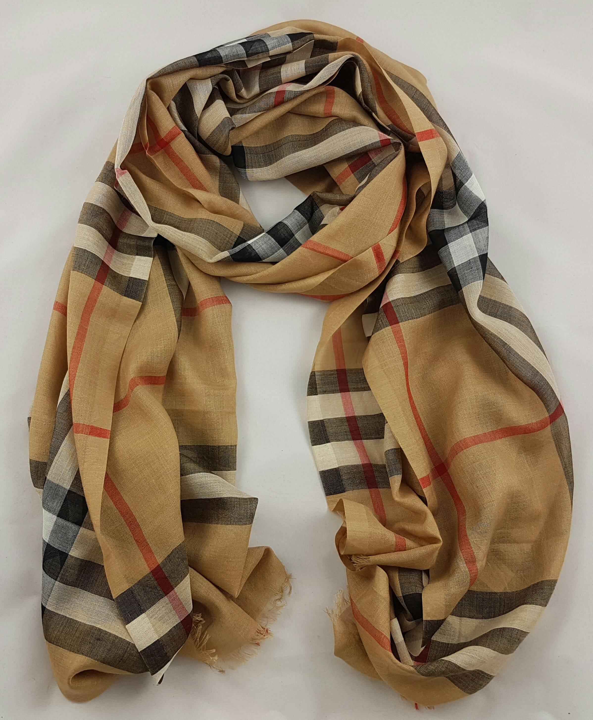 Burberry Stole, Camel

Burberry Lightweight Check Wool and Silk Scarf
Ash Rose Colour. Made in Italy
51% wool and 49% silk
Eyelash fringing at both ends
This gorgeous shawl is still in perfect condition.

Width 220 cm, Height 70 cm (86.61