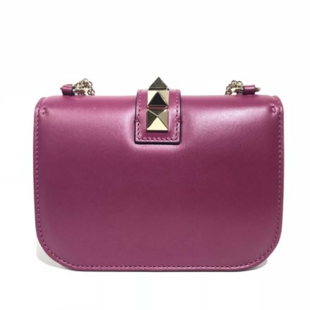 Valentino Small Rockstud Shoulder Bag.
Brand new condition with cards and dustbag. 
Limited edition plum color. 
Leather. 
Gold hardware.
Size - 8"L x 6"H x 2.5"W