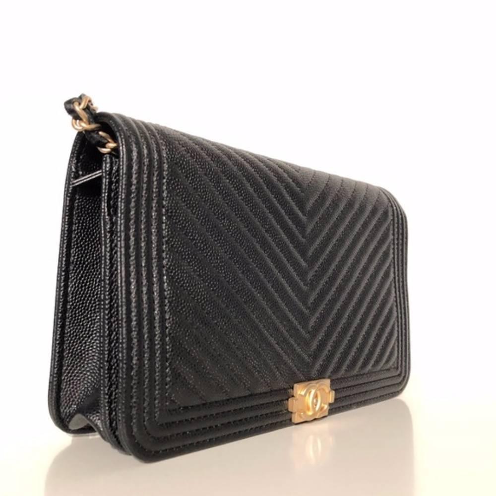 Chanel Chevron Boy WOC caviar black
Sold out in stores. 
Brand new condition. 
Black caviar leather. 
Gold logo and chain. 
Magnetic closure. 
COA and dustbag included. 
Made in Italy.