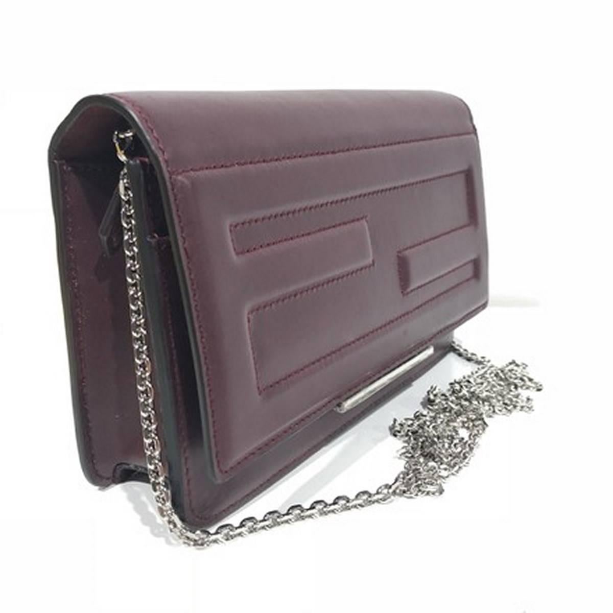 Brand new. 
Leather. 
Removable chain shoulder strap, 21.5” drop. 
Flap top with logo engraved bar, snap closure. 
Interior zip and slip pockets, six card slots. 
Made in Italy.
Size: 7.5"L x 4.9"H x 2"W