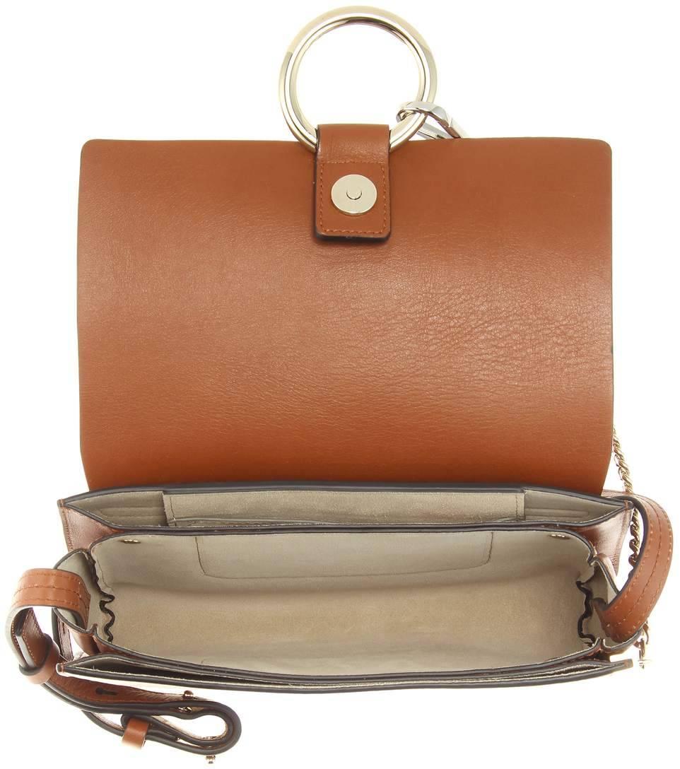 Chloé's Faye bag is timeless and elegant. In light brown leather, it features an orange suede flap 

to the front and is accented with a silver- and gold-tone loop and chain detail. Go hands-free by 

wearing it cross-body, keeping all your