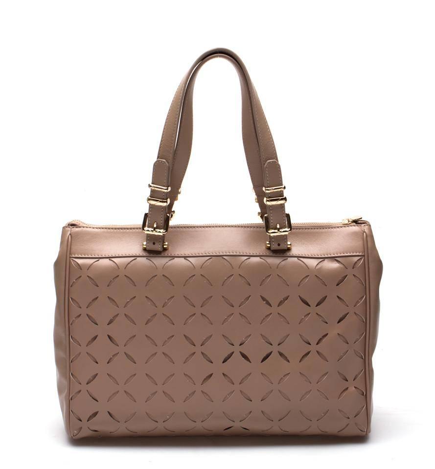 Versace Collection Laser Cut Leather Tote, Beige

This chic handbag uses a dual layer of leather with a laser cutout design in the top layer to create a visually appealing and intriguing look. Experience luxury every time you use this fabulous