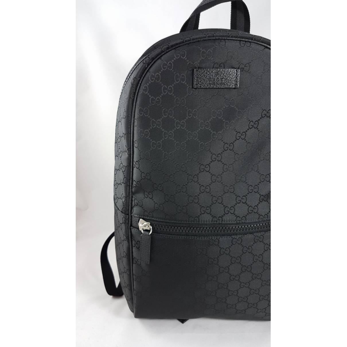 Gucci GG Guccissima Backpack.
Style 449181Smooth Black Nylon
GG Guccissima Pattern
Exterior Front Zip Compartment
Web Stripe Top Handle
Zip CloseAdjustable Padded Shoulder 
StrapsInterior Zip 
CompartmentInterior 