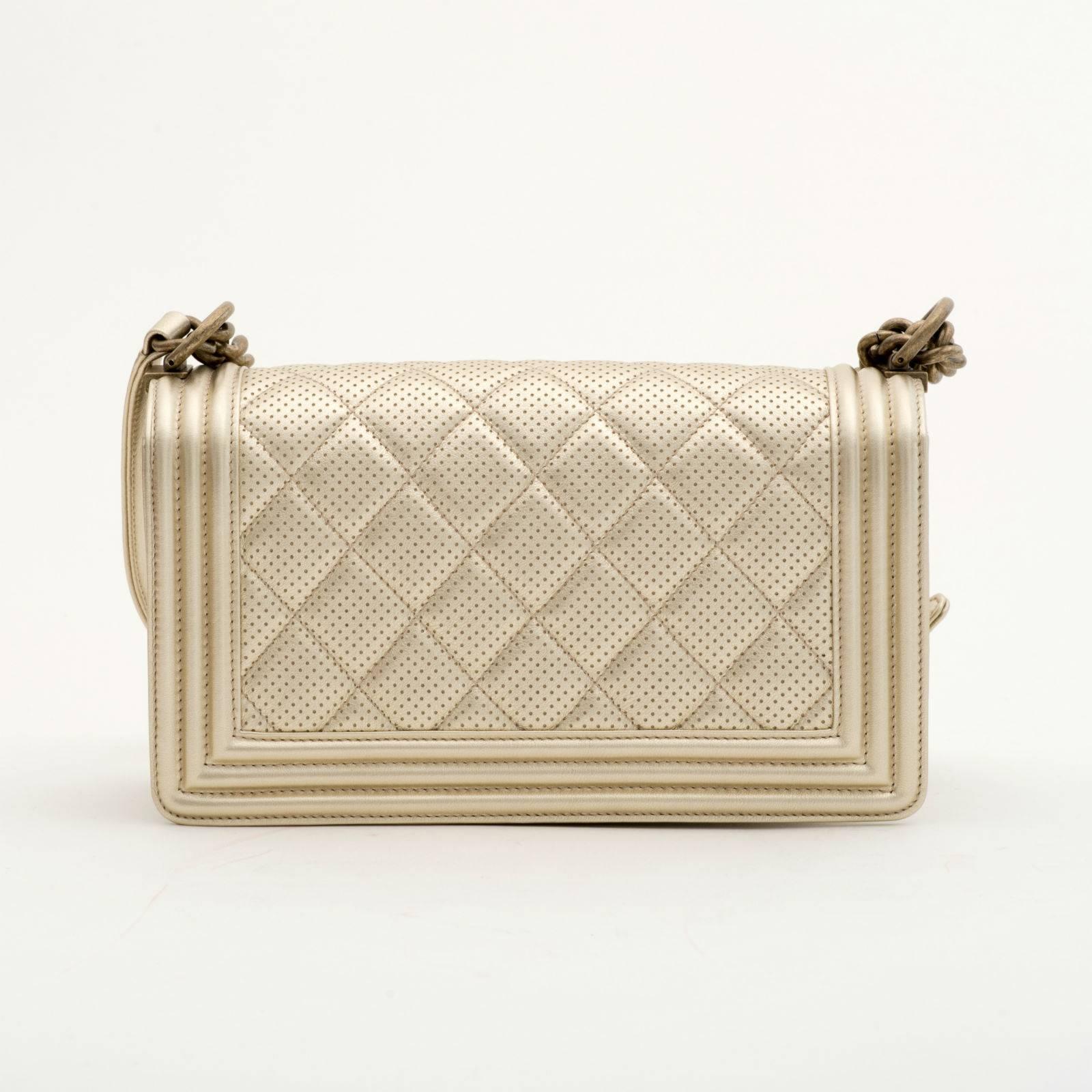 Chanel Perforated Quilted Leather Gold

Chanel Perforated Quilted Leather Gold perforated quilted leather with antique gold tone hardware.
This bag features a full front flap with the signature Le Boy CC push lock closure and a chain link, and