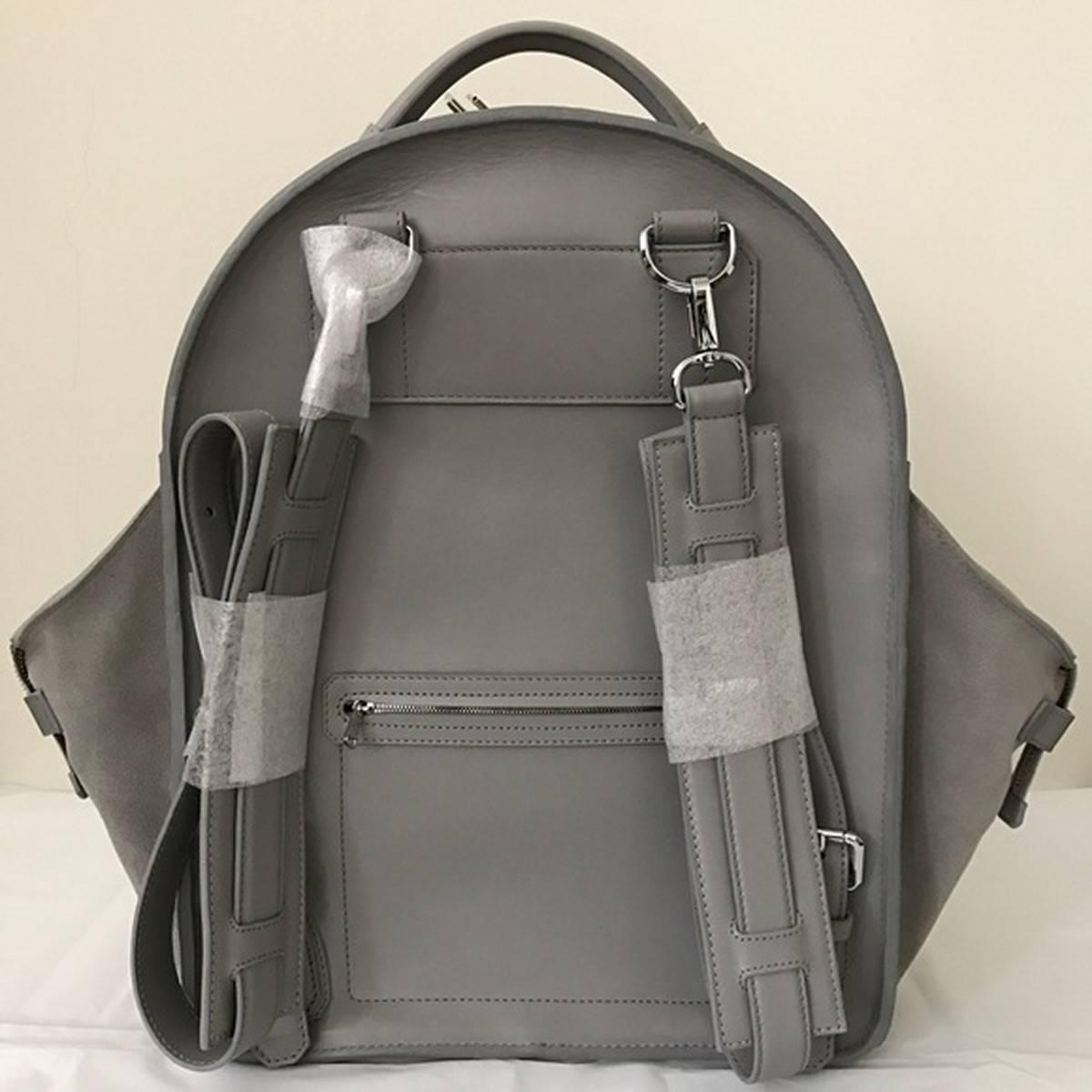 Brand new condition. Large size. Leather with suede side pockets. Back zipper pocket. Silver hardware and lock.

