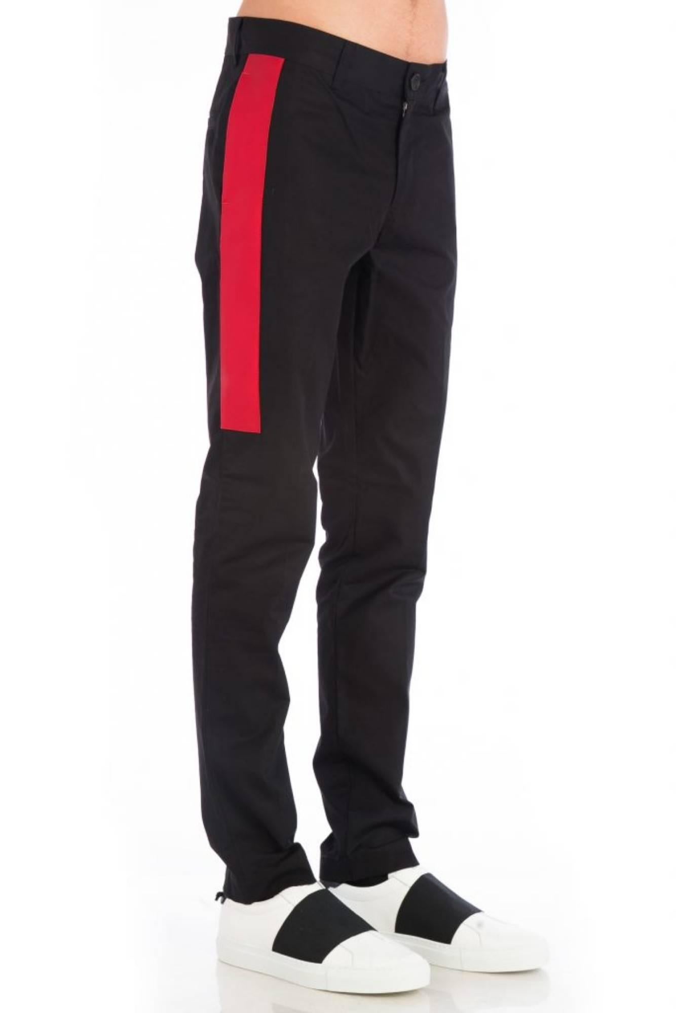 Side Stripe Trousers
Black tailored trousers
Red stripes on both sides
Mid-rise waistband
Button and zip fly fastening
Side seam pockets
Two rear welt pockets
Composition 100% cotton