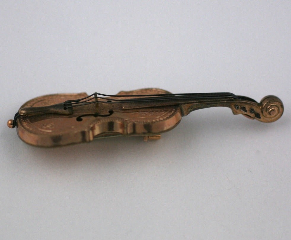 Wonderful figural brooch from the late 19th Century depicting a 3 dimensional realistic violin. Very likely made for a musician in the period.
Made of gold filled metal with extraordinary detailing. A charming wearable miniature.
2