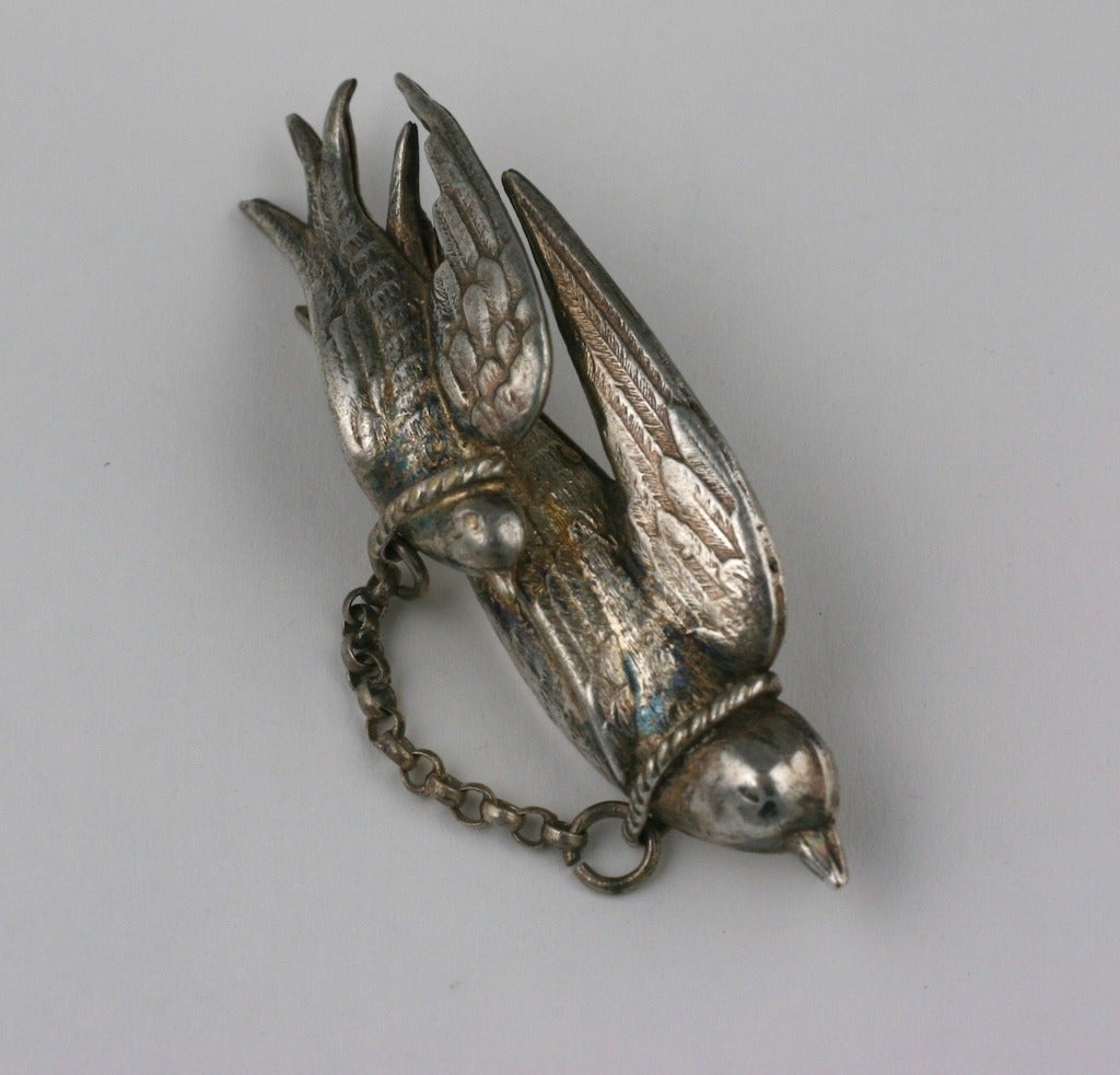 Victorian silver plate love token brooch of two tethered finely detailed turtle doves.
For the Victorians there was a close association between true lovers and Turtle Doves. These birds stay with their partners for their lifetime. Hence, they