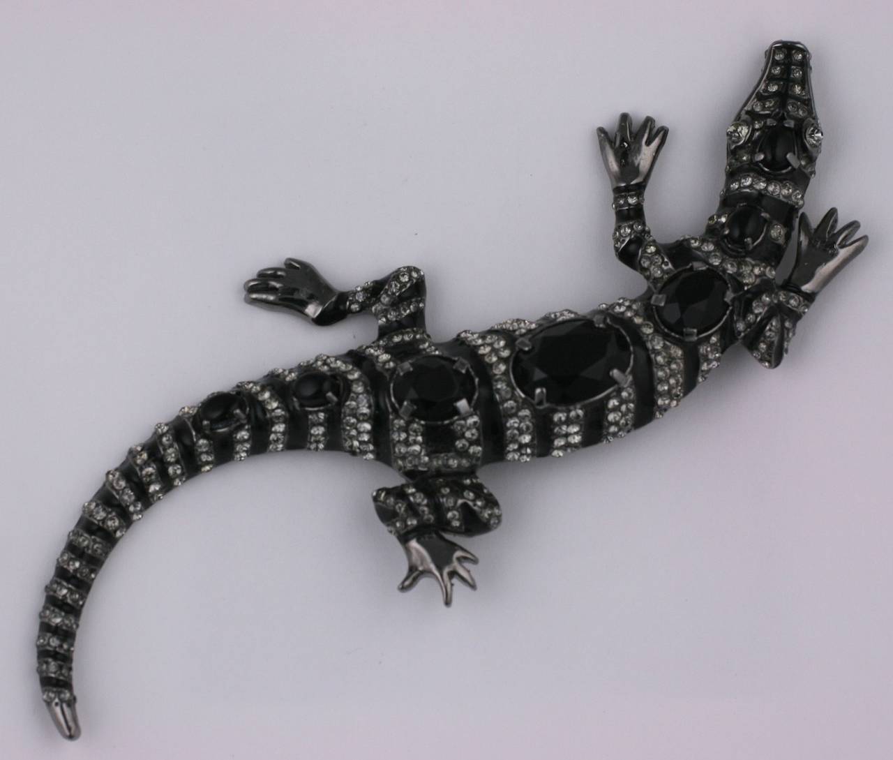 Large jet and pave set lizard by Valentino, Italy. Beautifully detailed work with pave crystal accents set onto an black enamel and antique pewter metal finished base. 
There are several large oval jets running down the spine of the lizard. 6