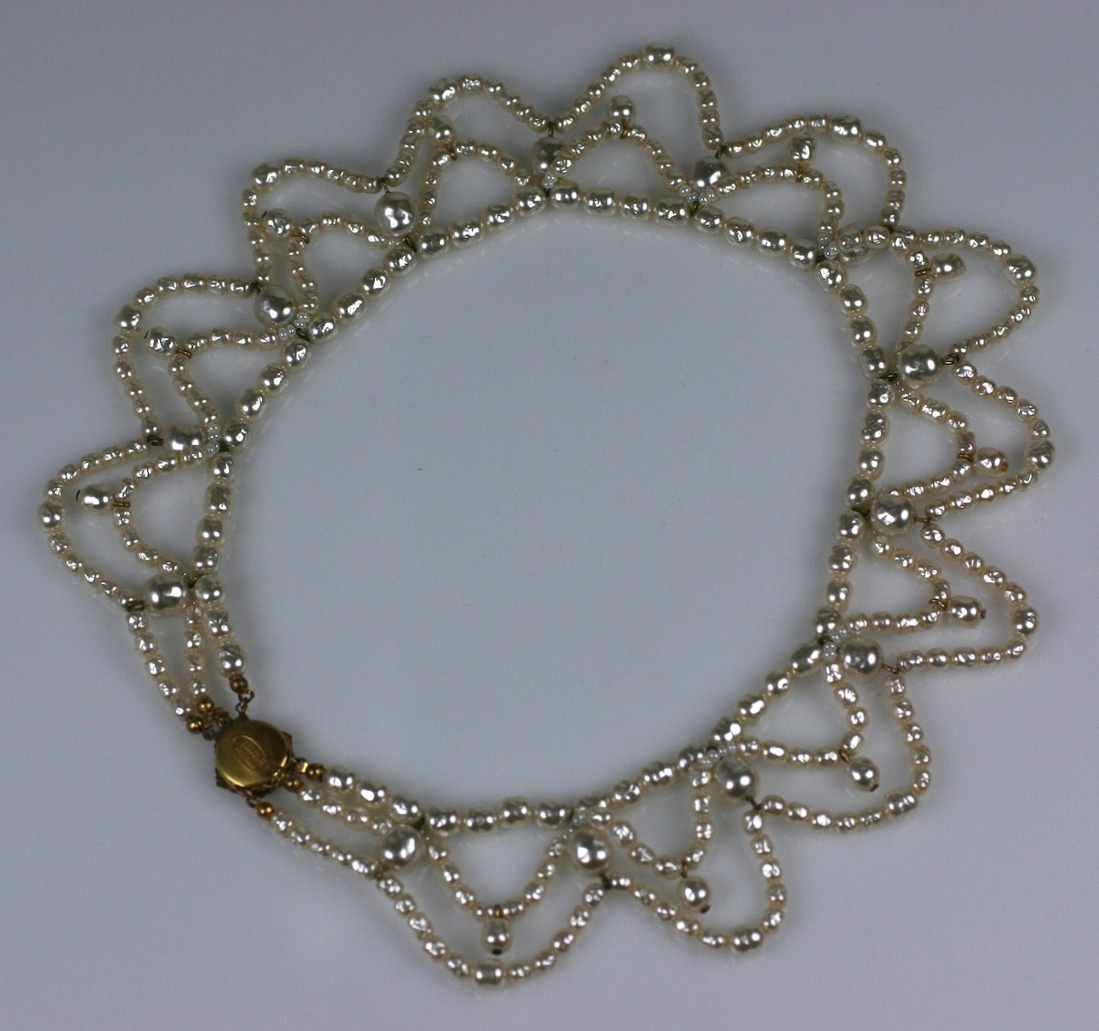Miriam Haskell's large festoon necklace of swags of creamy baroque pearls and drops all around. Signature Russian gilt filigree clasp. 1950's USA.
Excellent condition. Length 16