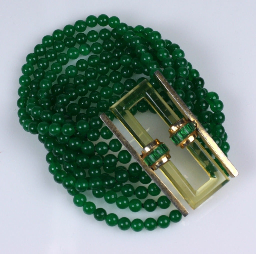 Wonderful Trifari Art Deco bracelet by Alfred Phillipe of faux emerald beads with a apple juice bakelite buckle clasp designed to resemble citrine. Emerald baguettes on the clasp tie the 2 tones together. 8