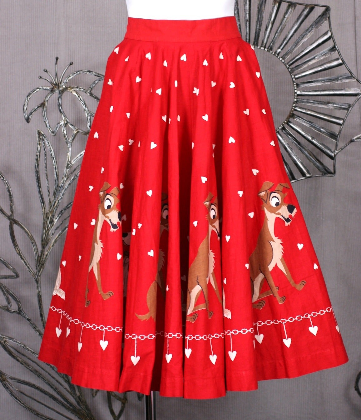 18 panel Lady and the Tramp collectible Disney skirt.. Originally sold in kits, this charming red cartoon circle skirts is covered with hearts, chains and the enamored couple along the hem. Dress maker quality. Excellent condition. 
The 18 Panel
