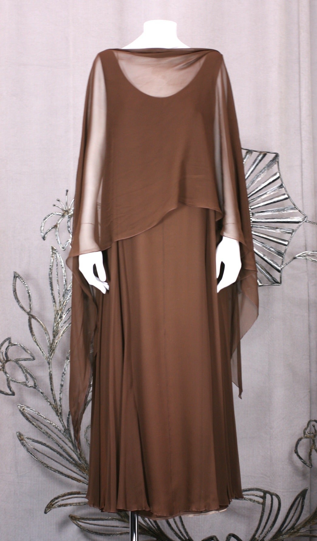 Easy brown chiffon gown by master tailor Stravapoulos in 4 ply tonal chiffon. Outer layer is brown and graduates coffee, pink and flesh chiffon closest to body. The dress is a simple tank design with a large bias chiffon stole which can be used as a