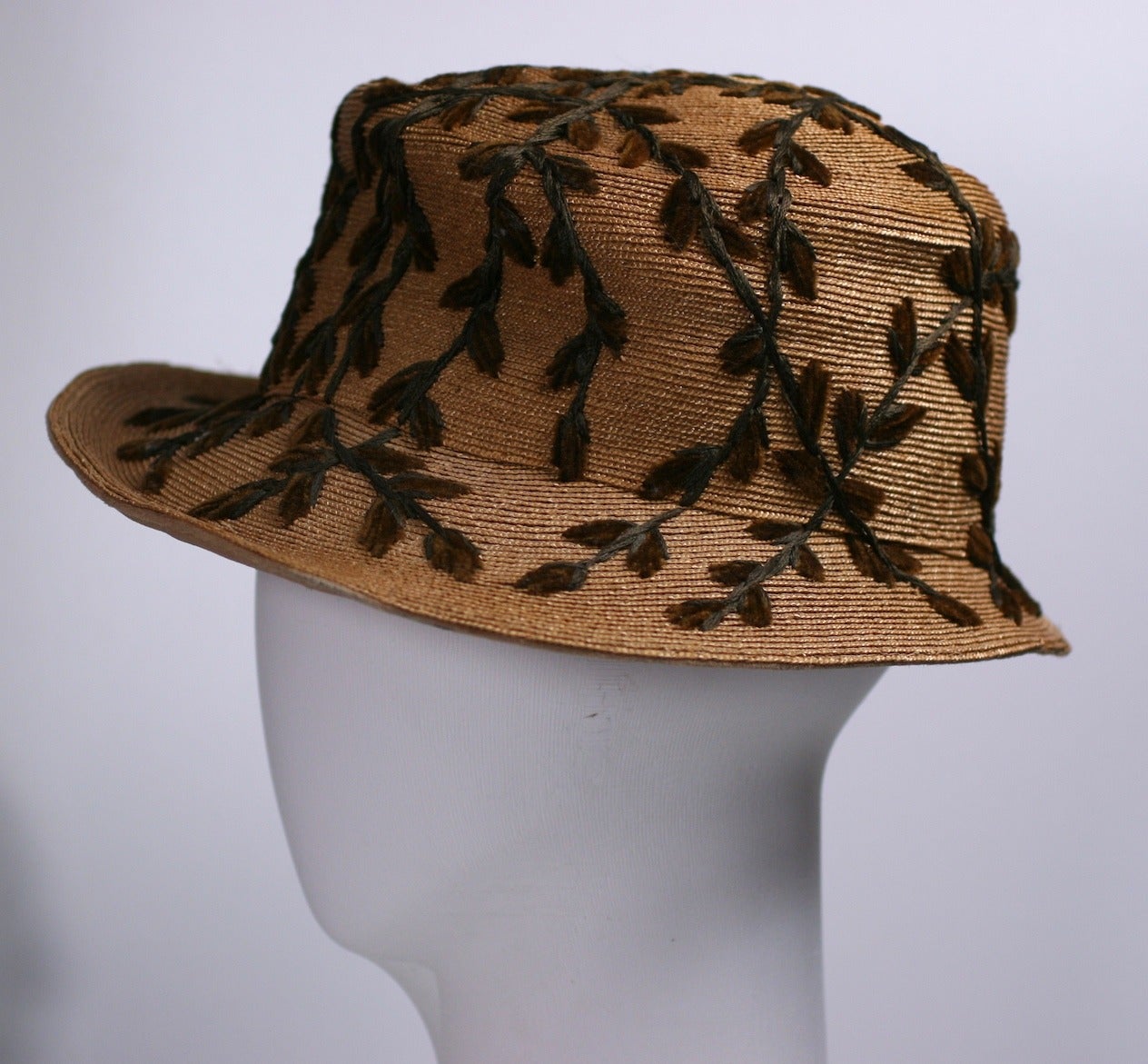 Charming Edwardian straw hat with chenille pussy willow embroidery. The pussy willows climb in all different directions across the crown and brim. 
Retailed by Curtis, NY. 3.5