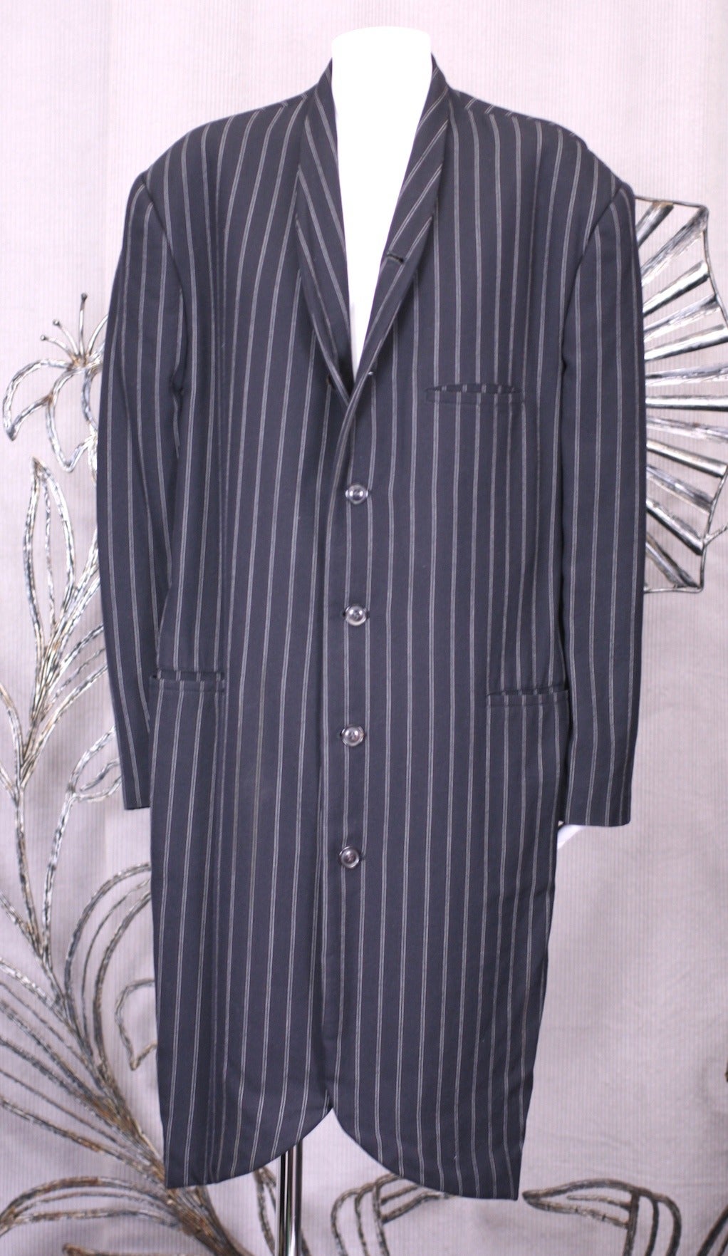 Yohji Yamamoto wool pinstriped mourning style coat with faux horn buttons and extended shoulder. 1980s Japan. Size M. Suitable for men or women. Unlined.
39