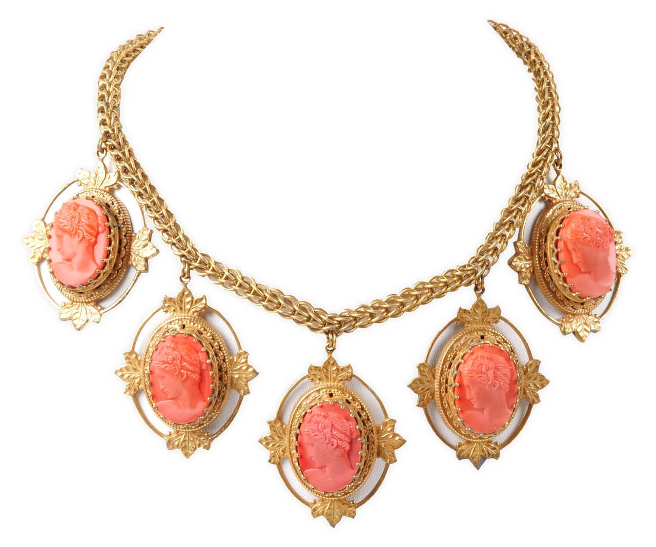 Miriam Haskell's coral glass cameo necklace set in signature Russian gilt filigree. Woven triple chain with 5 neoclassical cameo pendants set in filigree leaf frames.
Length 2
