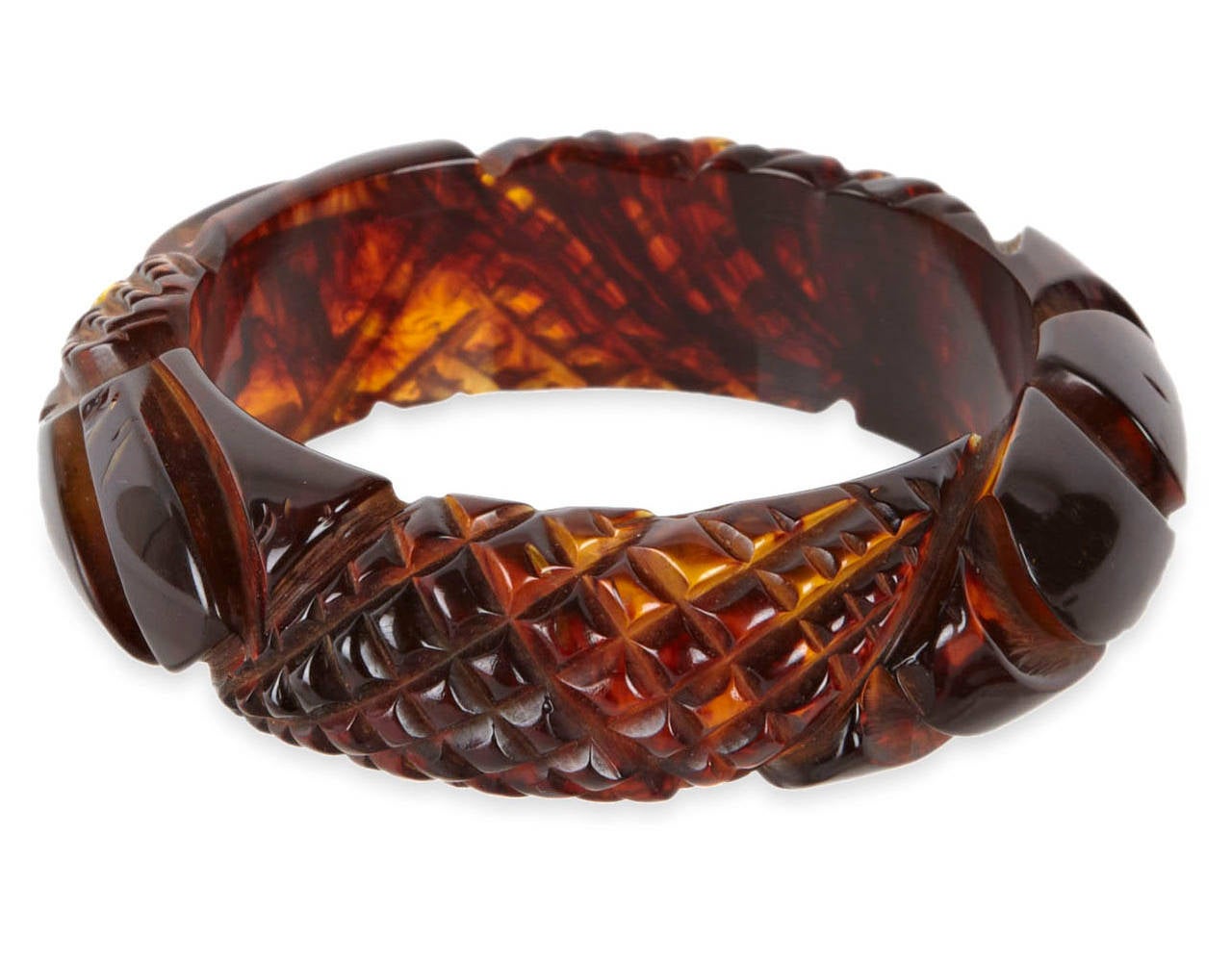 Thick and densely carved tortoise/root beer bakelite bangle circa 1930's. Floral and crosshatch motifs. 1