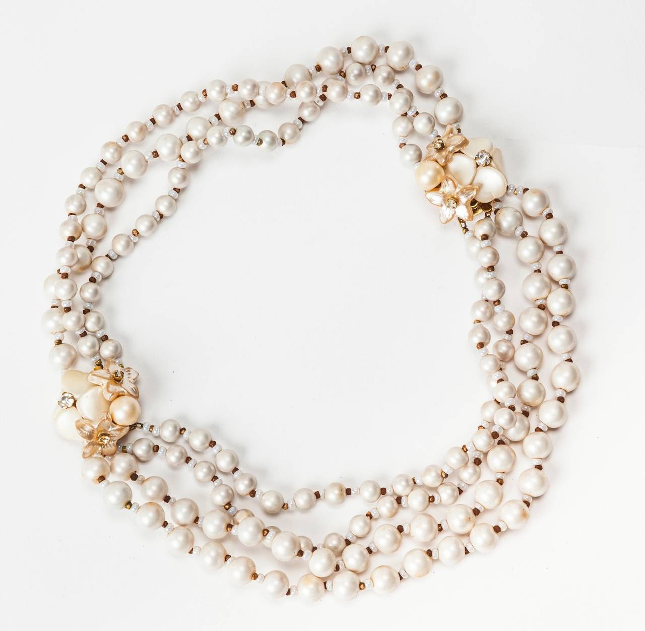 Miriam Haskell's signature freshwater faux pearl, diamante and gilt transformation necklace with floral clasps which can become 2 bracelets. One bracelet has 3 strands and the other has 4, all with gold seed bead spacers. 1950's USA. Perfect wedding
