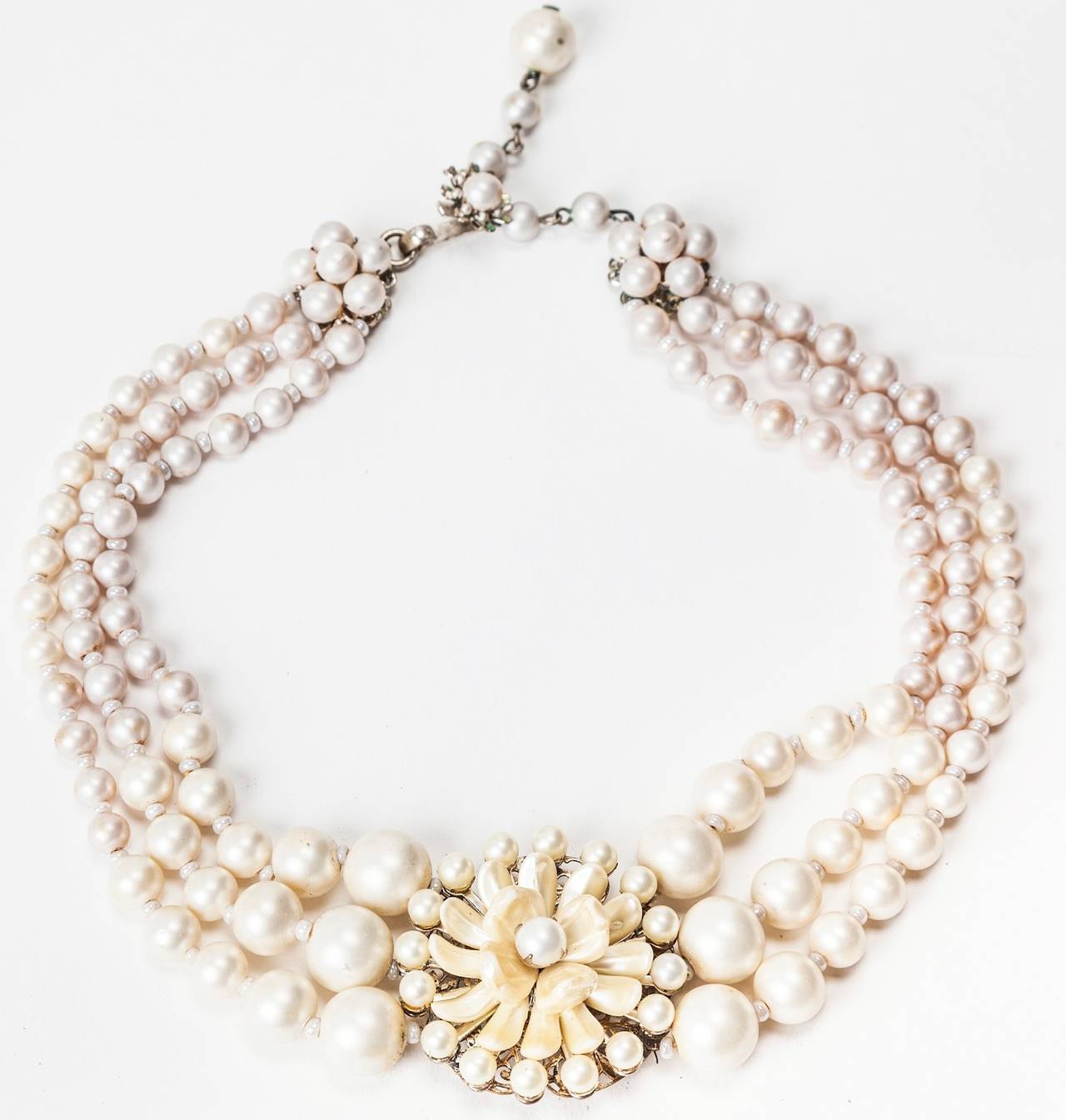 Miriam Haskell's freshwater pearl dahlia necklace in signature summer white. Necklace is graduated three strands of  freshwater faux pearls and petals sewn on silver gilt metal findings. Perfect wedding jewelry. 1950's USA.
Excellent condition.